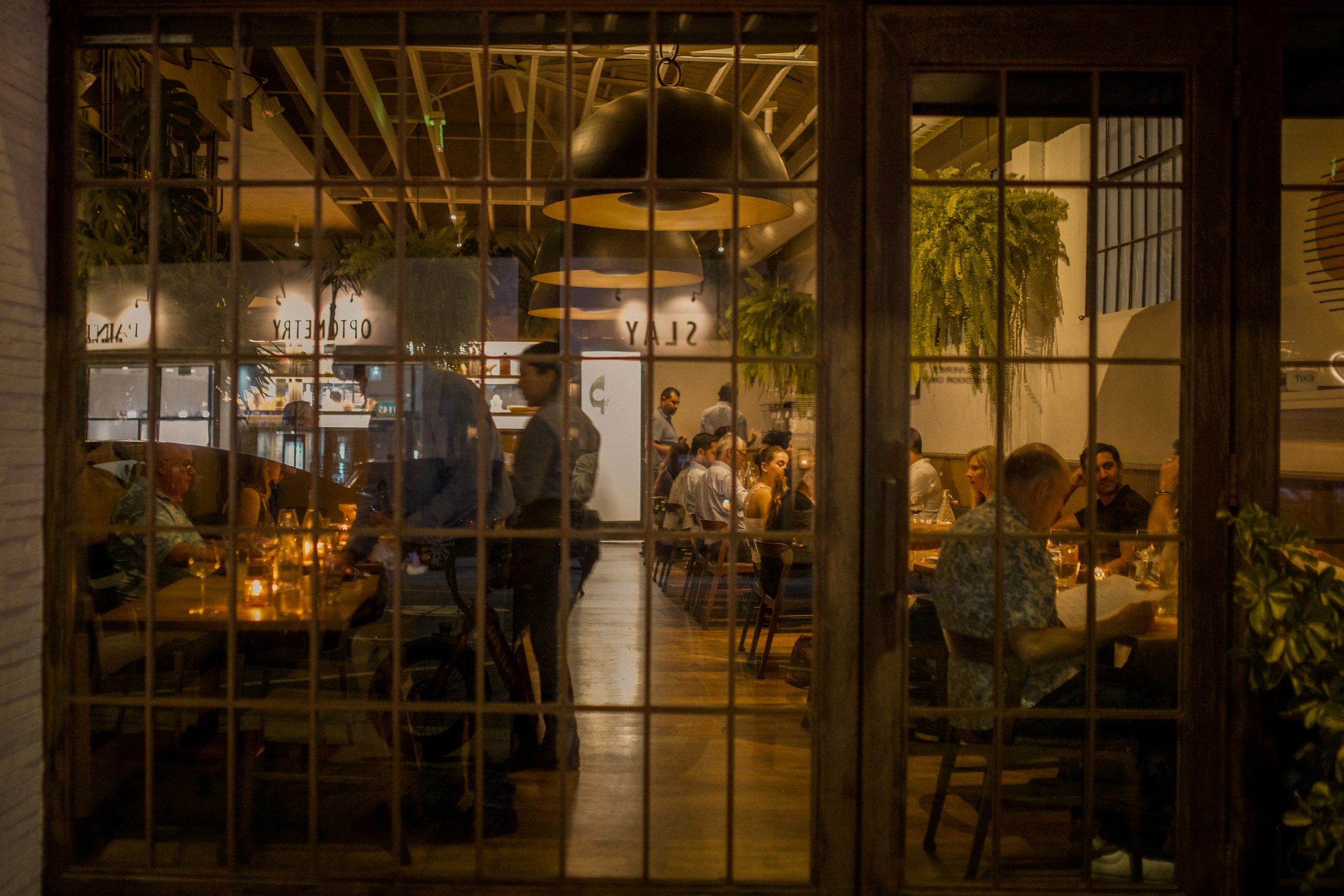The M.B. Post dining room at night, seen through the front windows