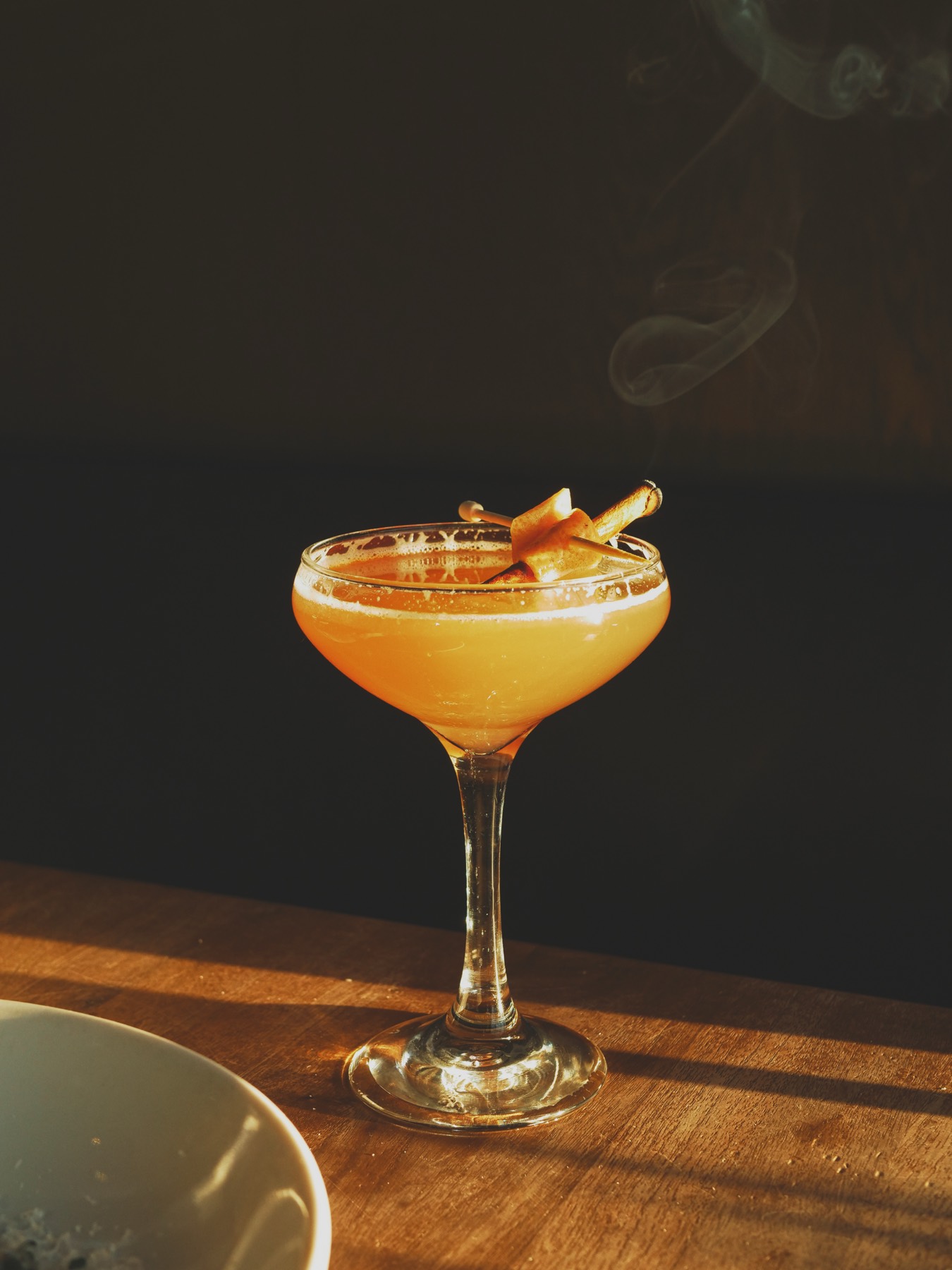 A smoked cocktail in a coupe